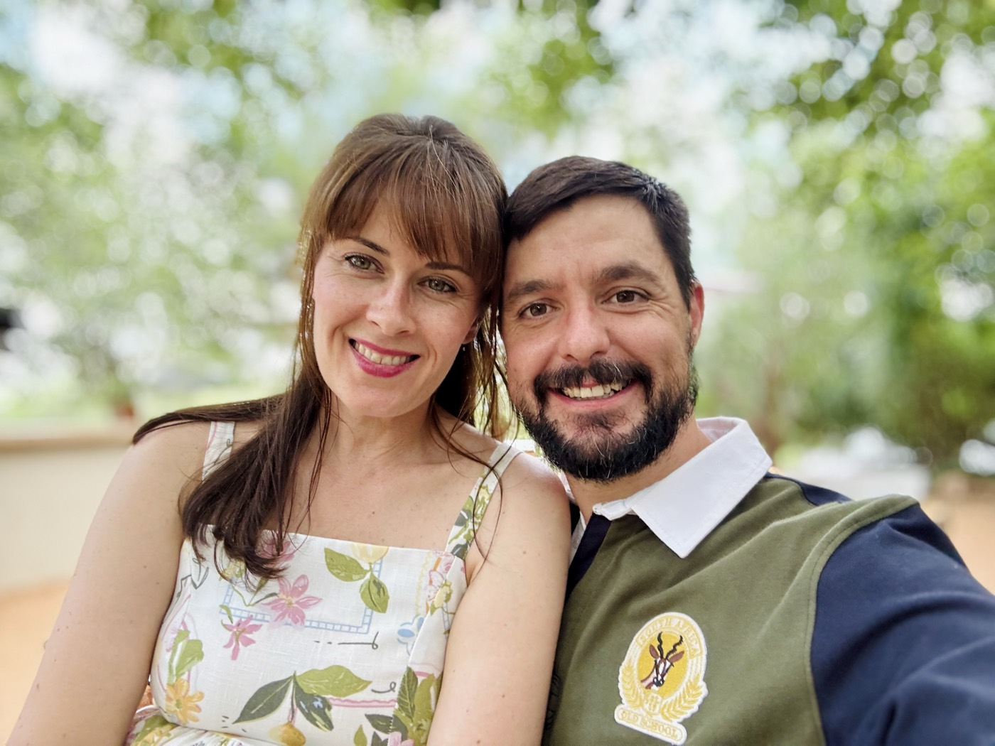 Ruan and Jenny, the owner-hosts of Muunga, outdoors under the trees at the lodge.