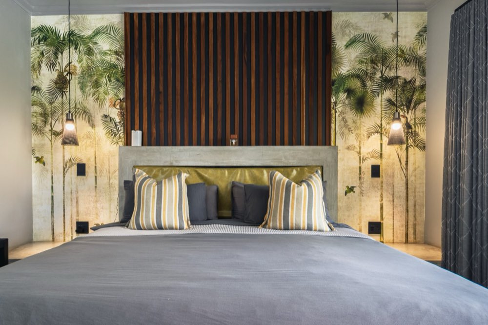 Close on the Superior Bush Suite headboard — timber slats, a gold panel and striped cushions.